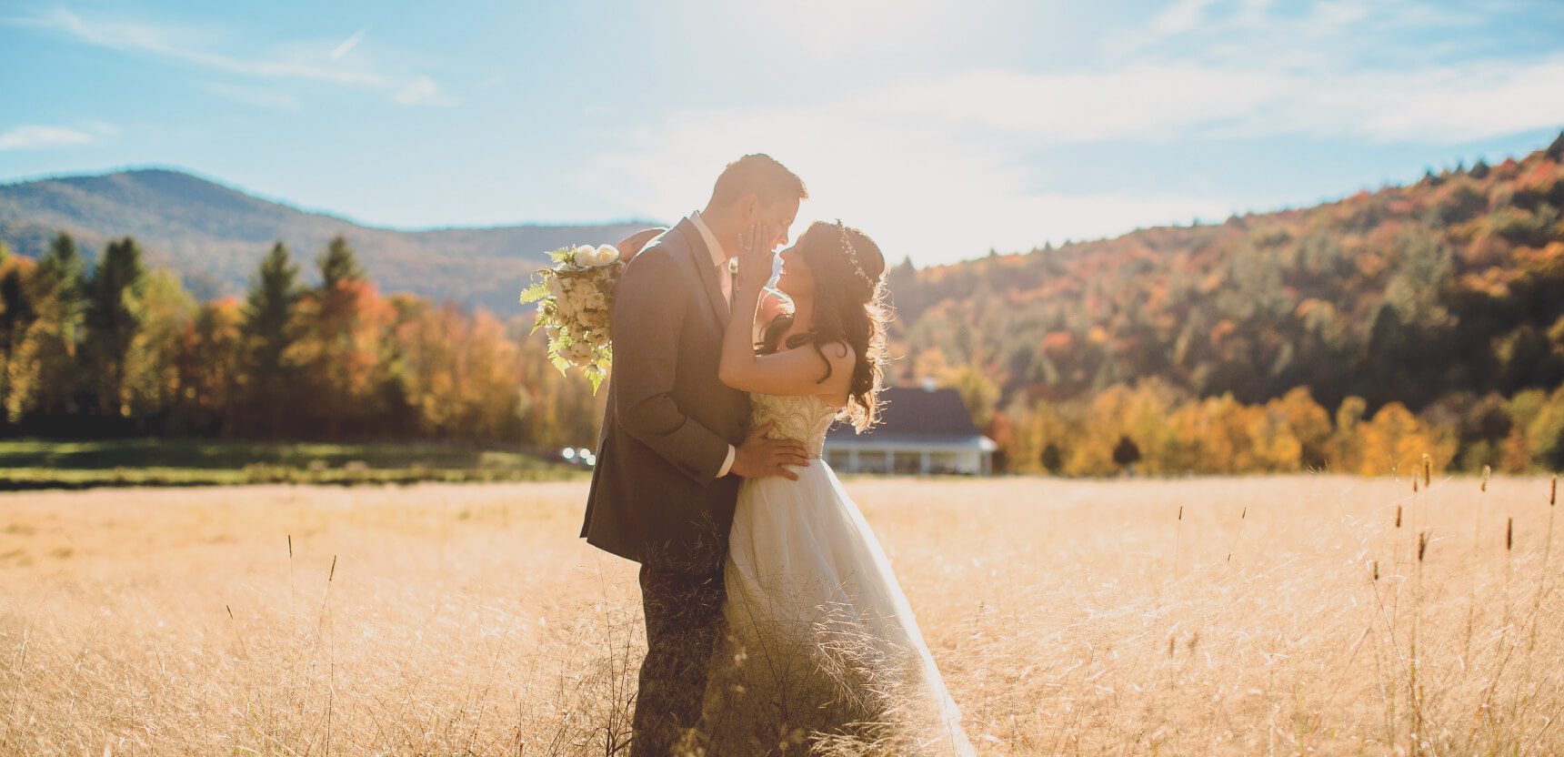 A couple in a golden Vermont meadow at Riverside Farm